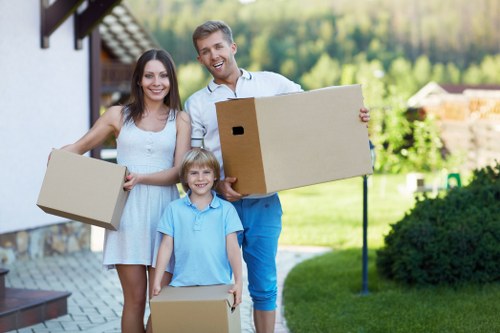 Professional movers carrying furniture in a Greenwich apartment building