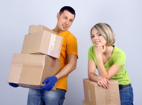 Mover wearing PPE while handling a heavy item