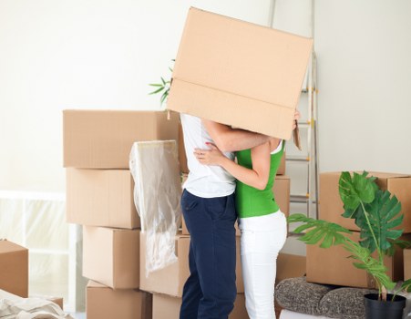 Packing boxes for a move in a Greenwich home